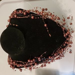 Floating long brown beaded necklace.